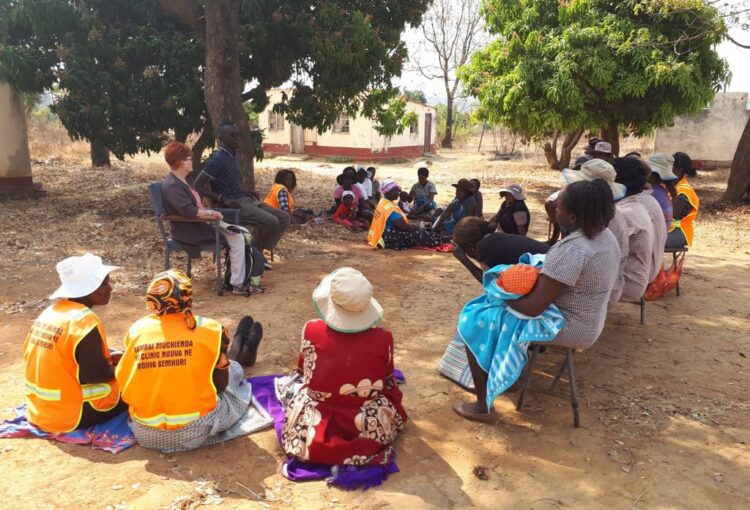women sitting under tree